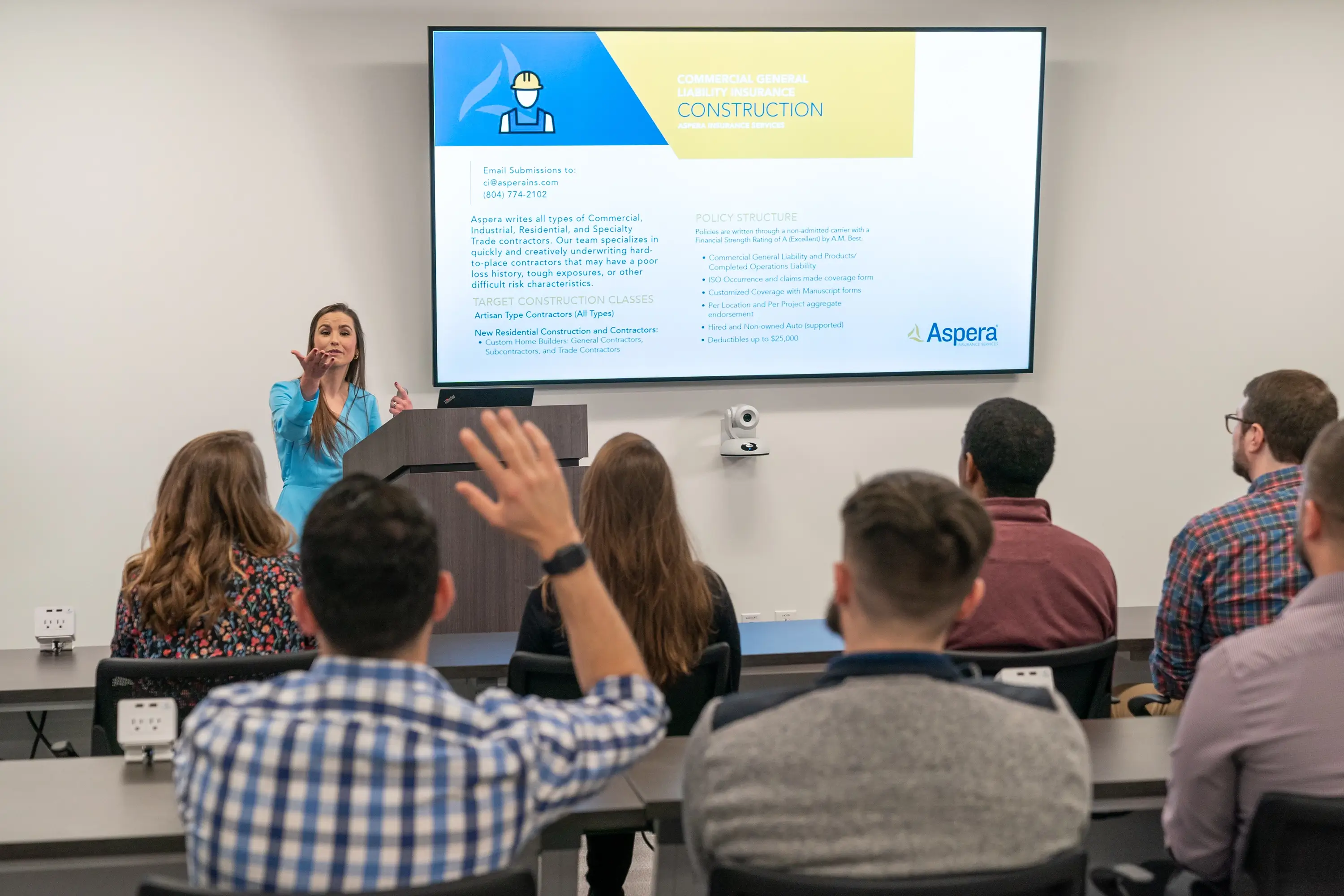 A presenter for Aspera speaking on insurance in construction.