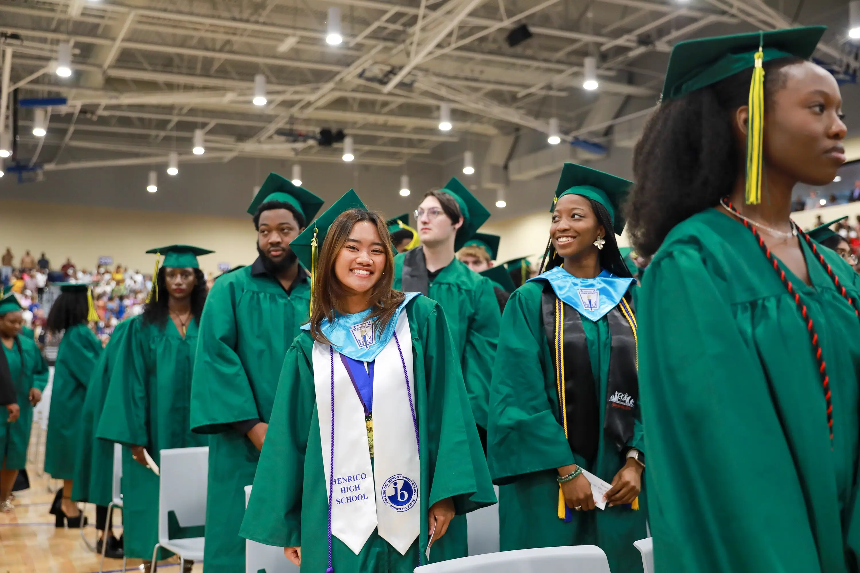 Students in green graduation gowns for Henrico High School's graduation ceremony