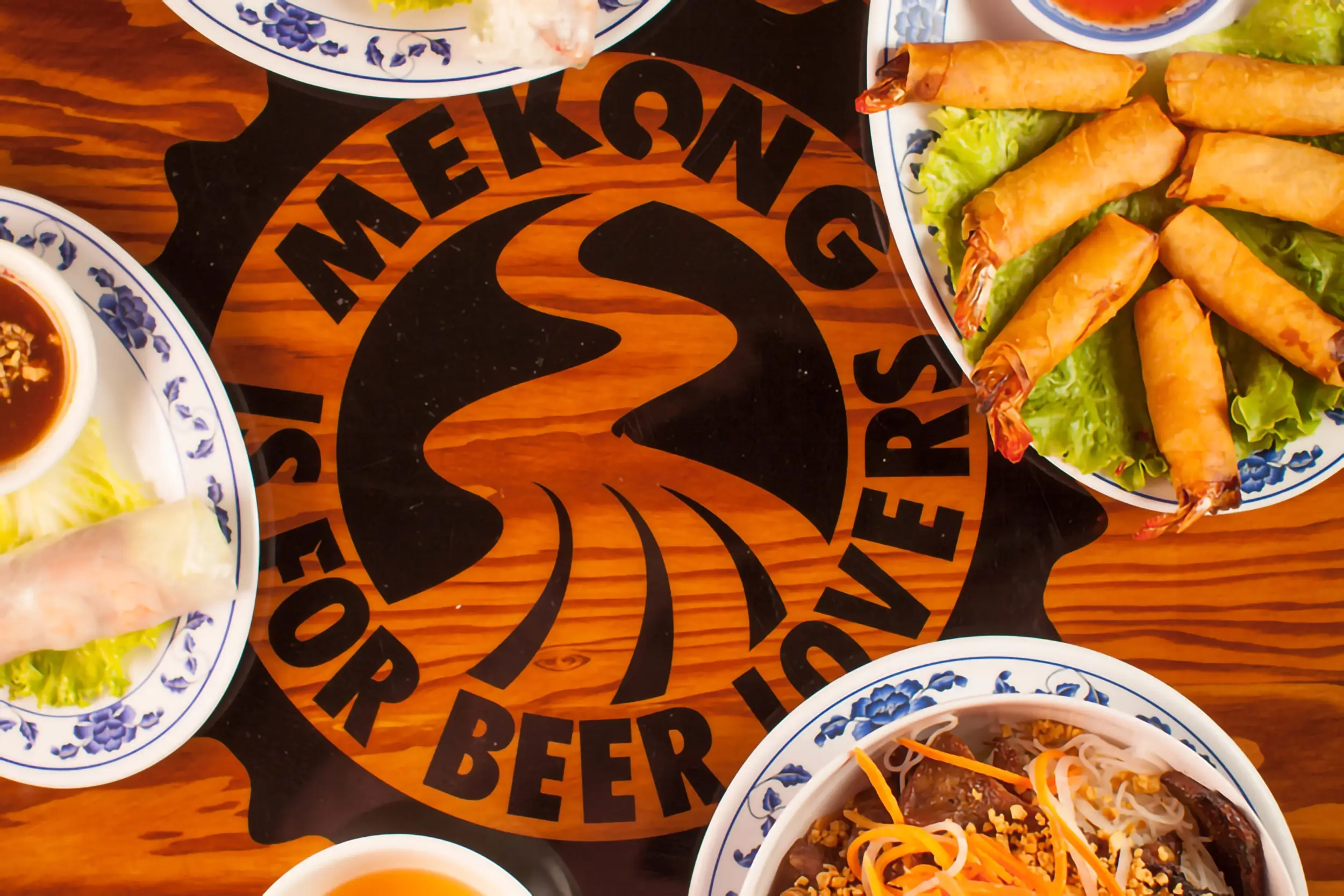 A table setting with the Mekong logo on a table