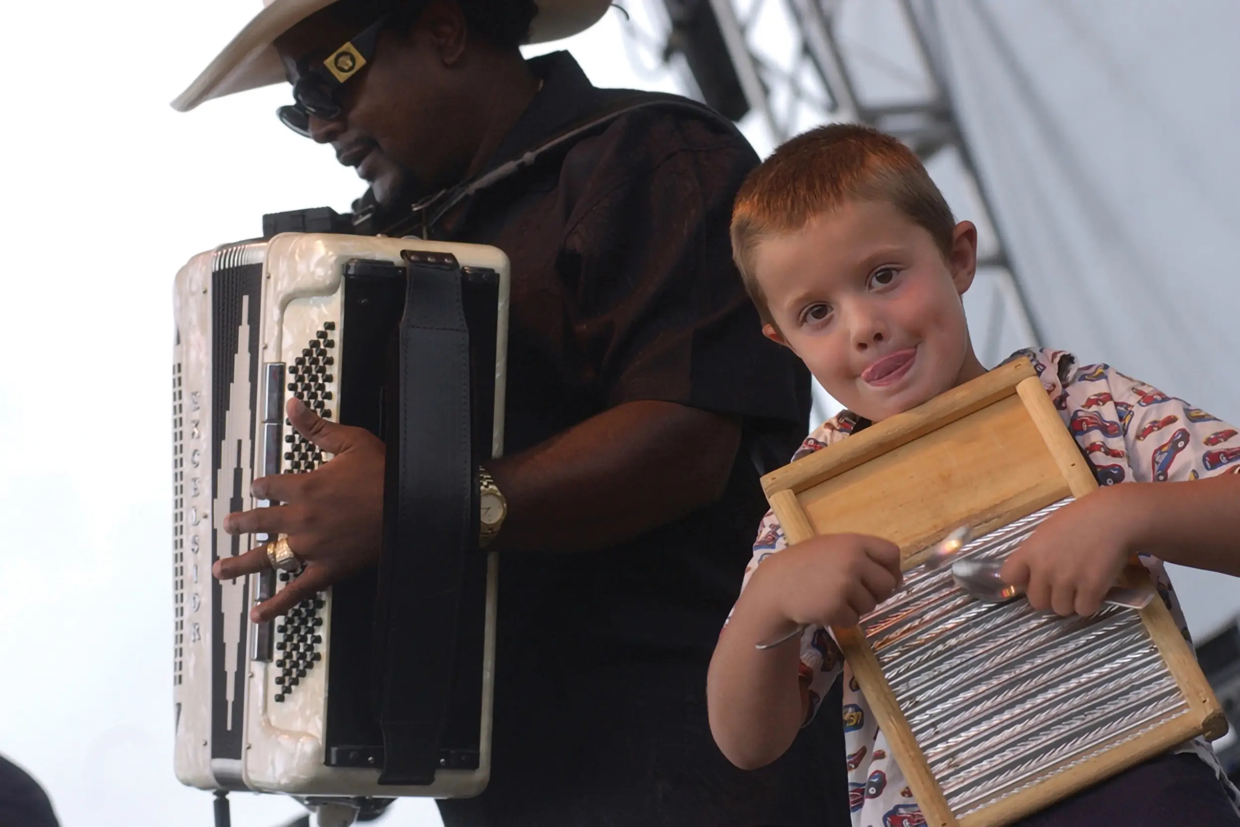 A man with an accordian and a boy with a washboard at the Richmond Folk Festival