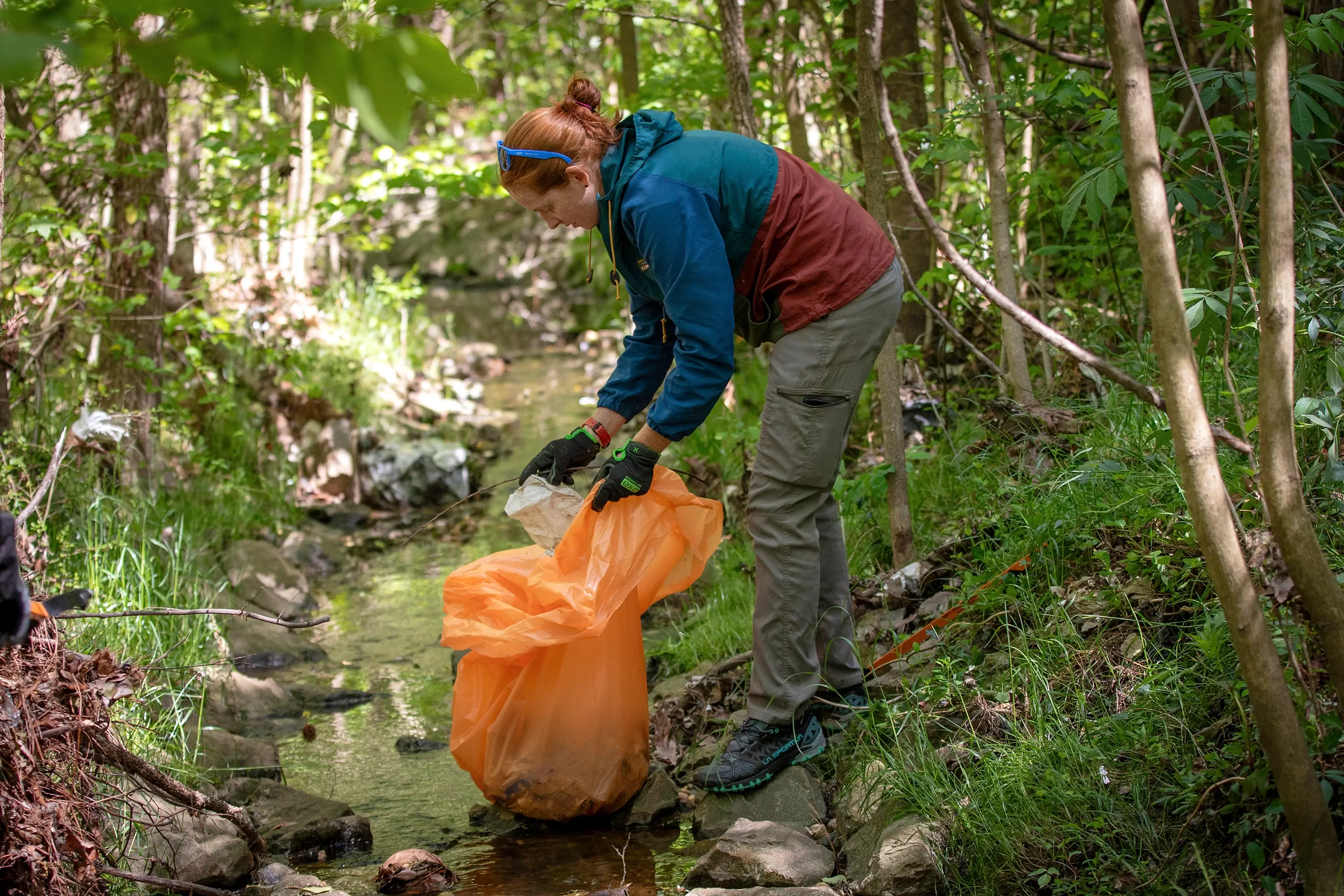A woman in Rocky Branch cleaning trash