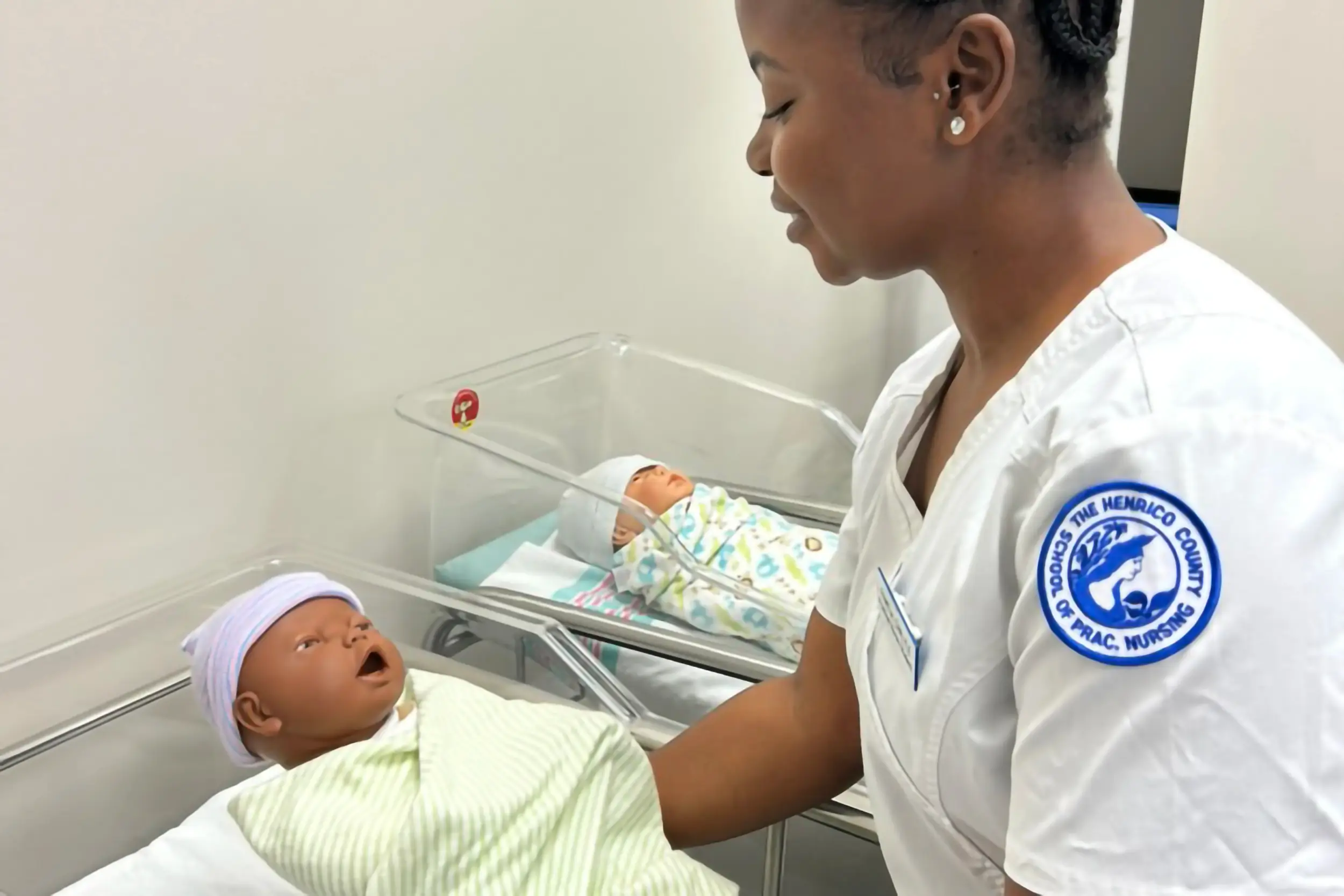 A woman practicing with a baby doll