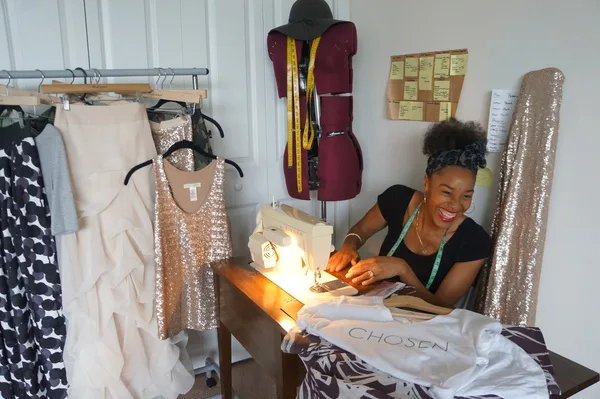 Woman sewing and smiling
