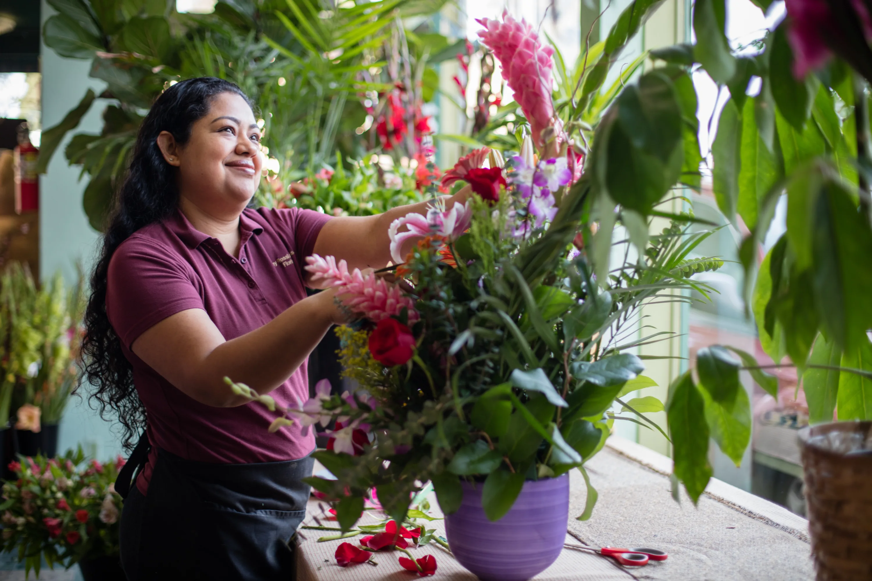 Woman arranging flowers in a planter